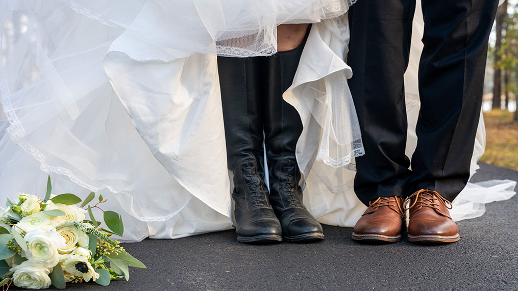 A bride and groom show off their footwear after a wedding at Oakfuskee Conservation Center.