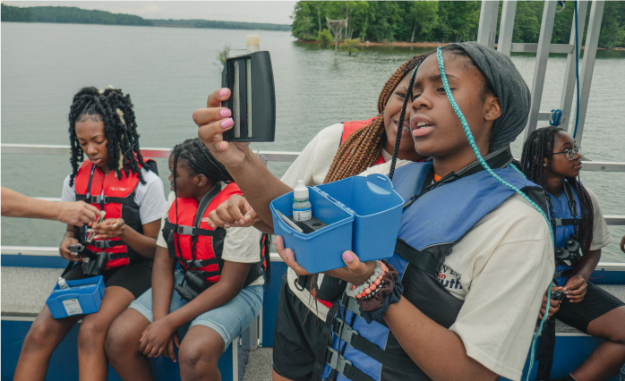 Students examine a water sample on board the Chattahoochee Riverkeeper Floating Classroom.