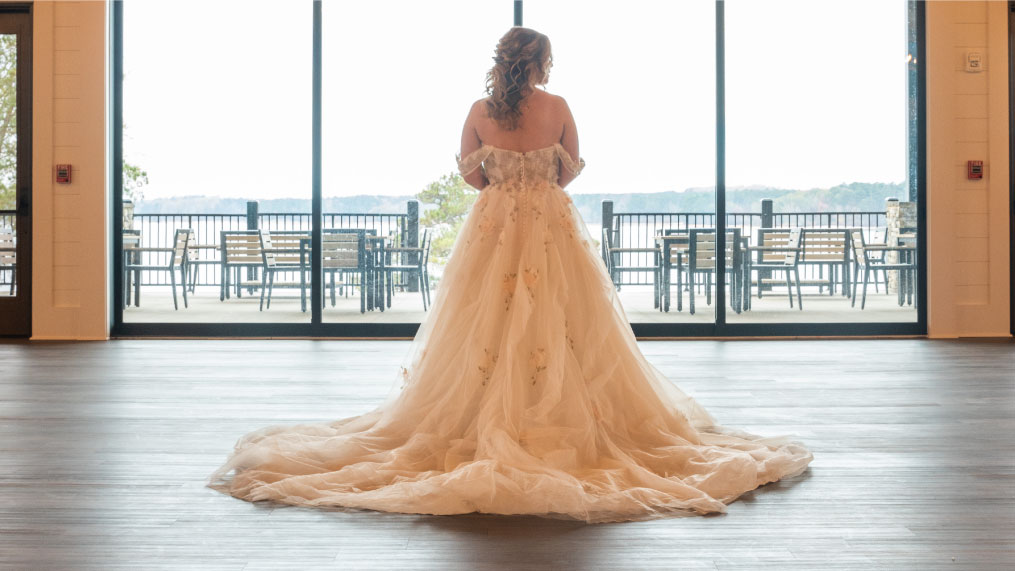 A bride takes in the view during her wedding at Oakfuskee Conservation Center.