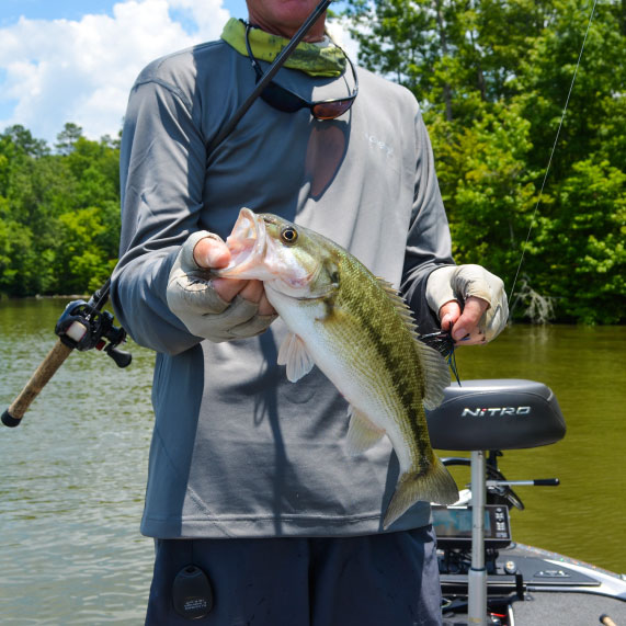 An angler shows off their catch, a small-mouth bass, while fishing on West Point Lake near Oakfuskee Conservation Center.