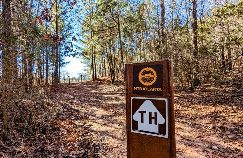 A trail marker designating Mountain Biking trails at Oakfuskee Conservation Center.